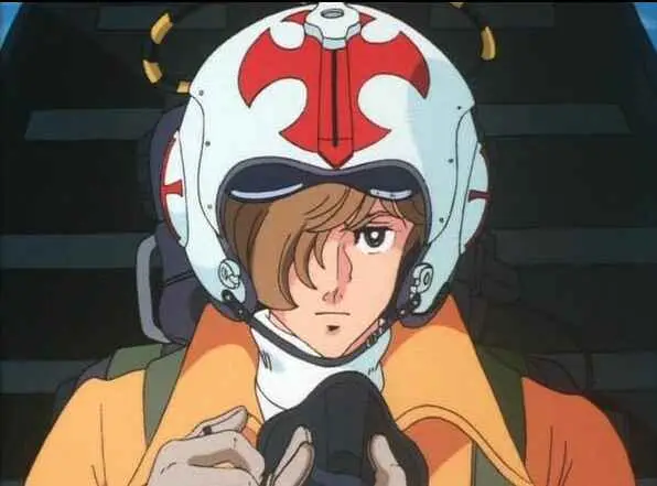 Close-up of a pilot wearing a white flight helmet with red markings, looking determined