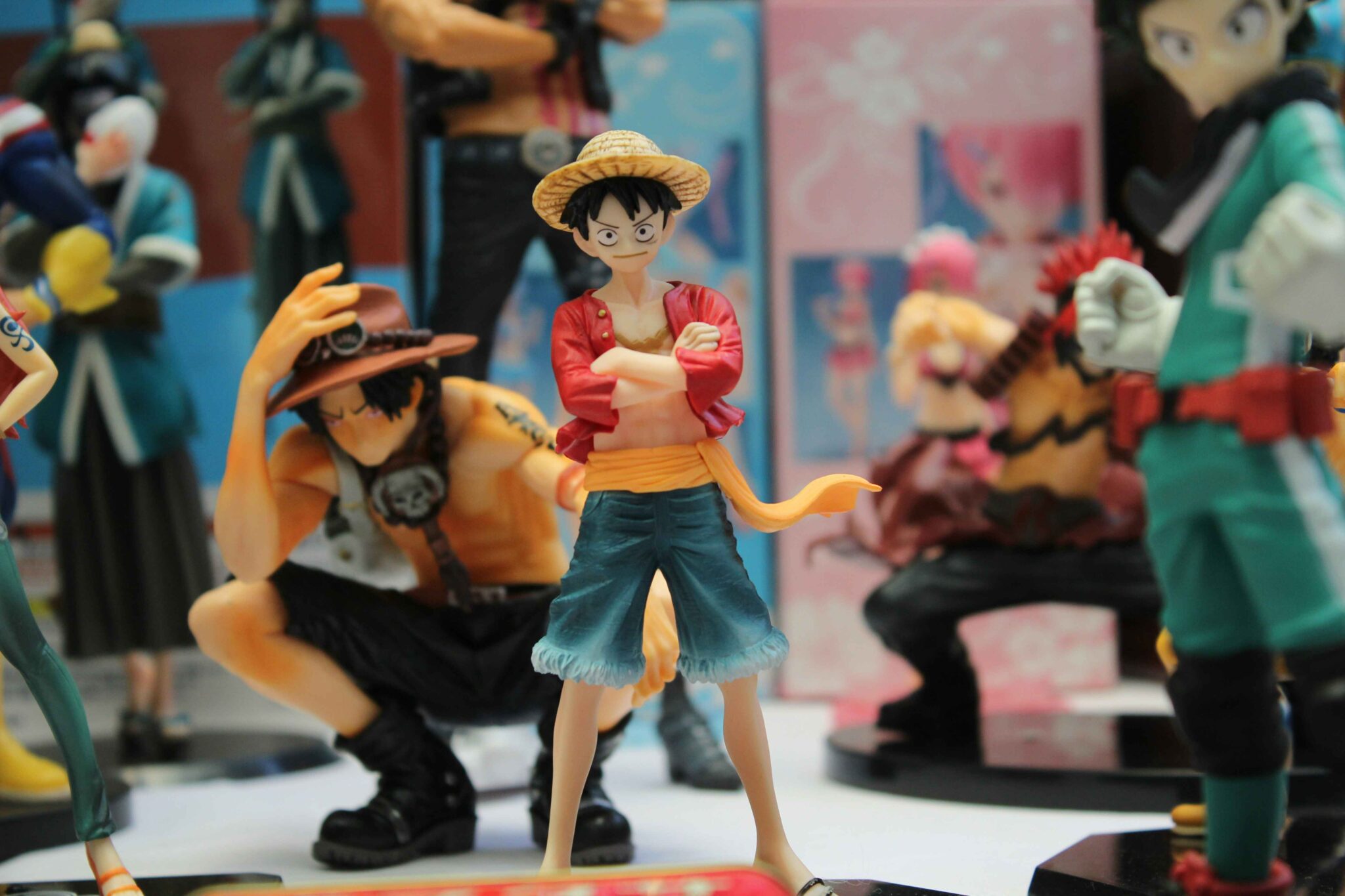 Close-up of Monkey D. Luffy and other anime character figurines displayed for merchandise sale.
